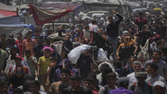 Palestinians carry bags containing food and humanitarian aid packages delivered by the Gaza Humanitarian Foundation, a U.S.-backed organization, in Rafah, southern Gaza Strip, Sunday, June 8, 2025. (AP Photo/Abdel Kareem Hana)