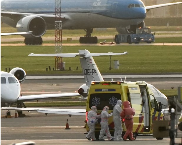 A person in a hazmat suit is escorted to an ambulance from a medical aircraft carrying evacuees from the MV Hondius at Schiphol airport, Amsterdam. Photograph: Lina Selg/AFP/Getty Images